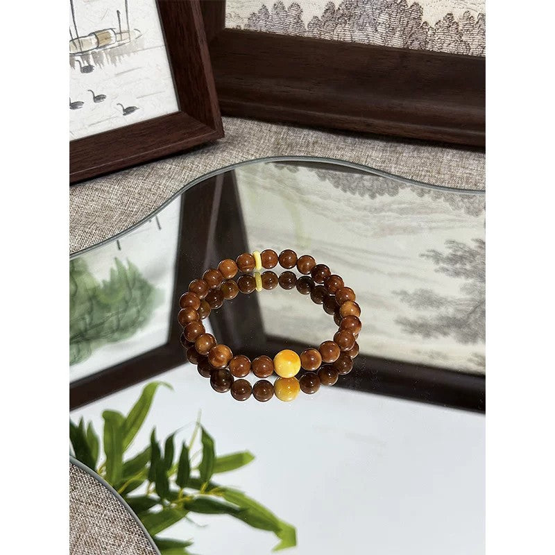 Kuk Bodhi 8mm bracelet with polished brown beads and pale jade-tone accent bead
