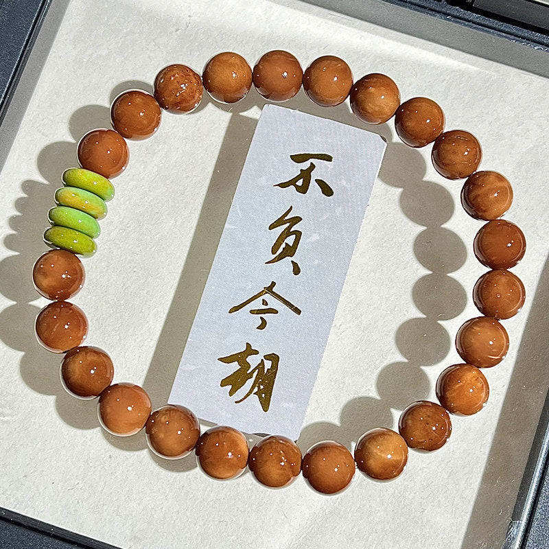 Kuk Bodhi 8mm bracelet with warm polished beads and restrained scholar-style accent composition