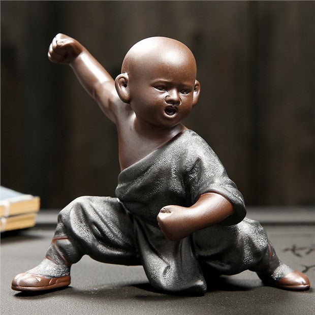 Charcoal robe Kung Fu monk figurine raised fist view