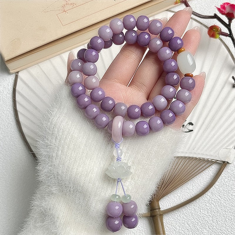 Lavender Bodhi root double-wrap bracelet with pale lotus charm, green accents and dangling bead tassel