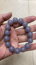 Lavender grey polished round stone bead bracelet in hand