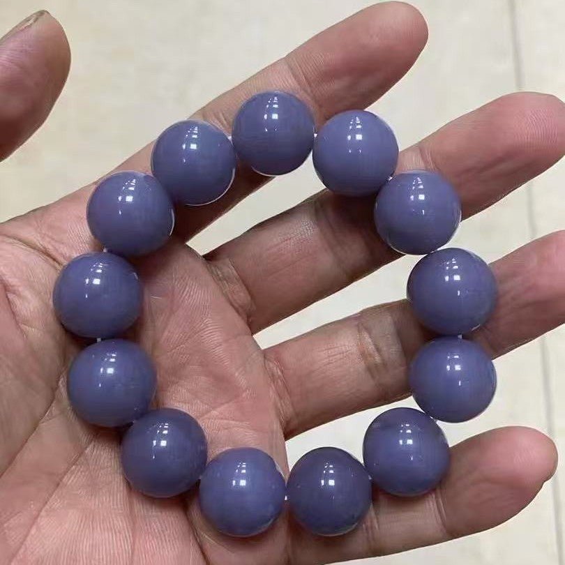 Grey violet stone bead bracelet showing glossy polished beads