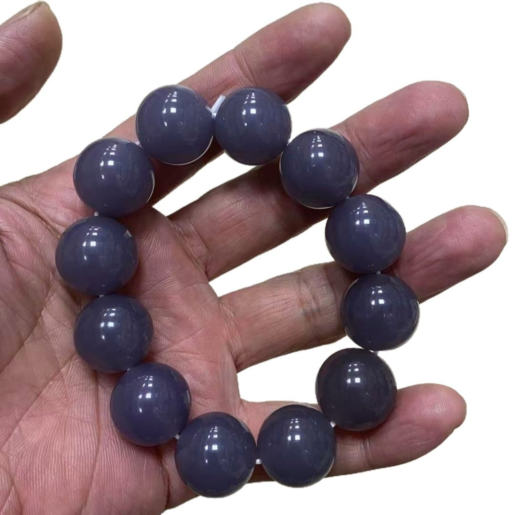 Polished grey violet bead bracelet on neutral background