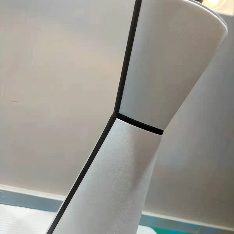 Close-up white leather texture and black trim on table lamp base