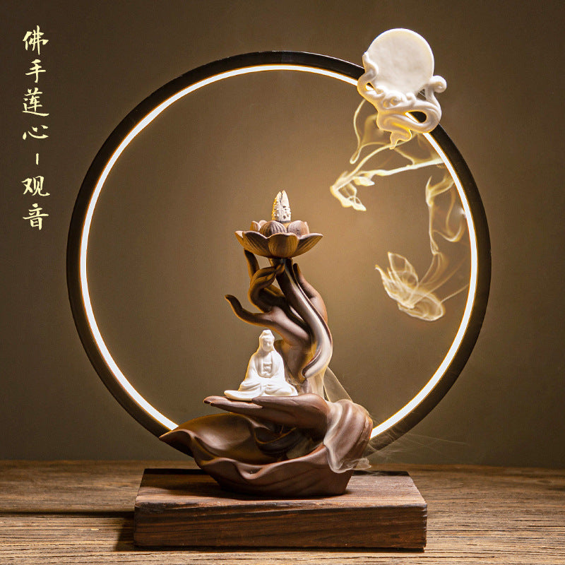 Zen Buddha incense display with circular LED light and smoke sculpture