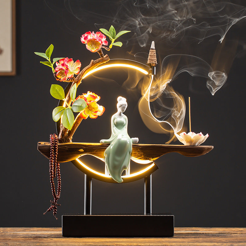 Camellia blossom illuminated incense display with classical Chinese beauty