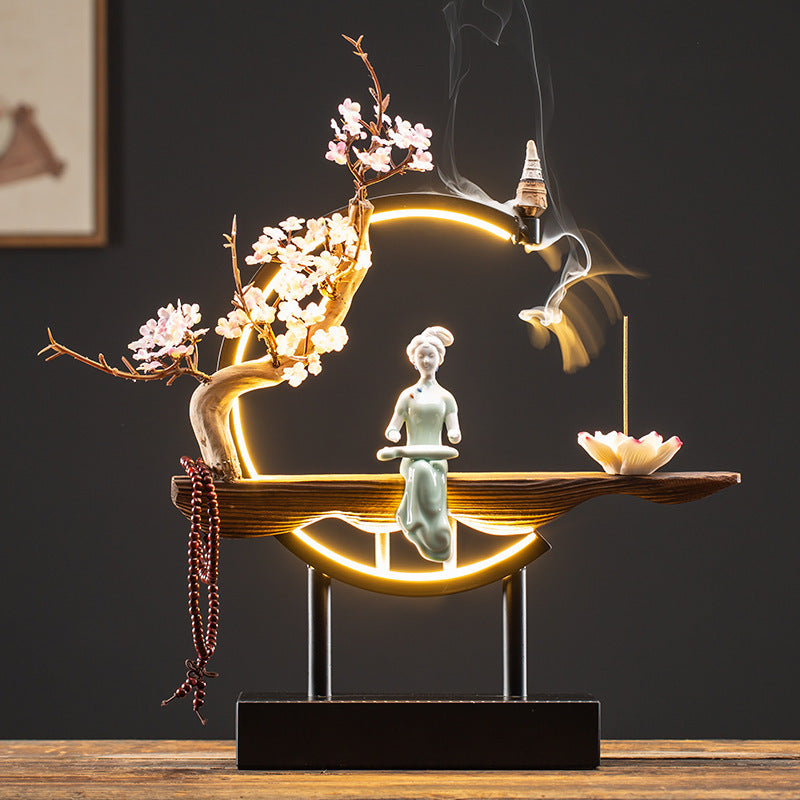 Classical Chinese beauty incense display with white blossoms and glowing ring