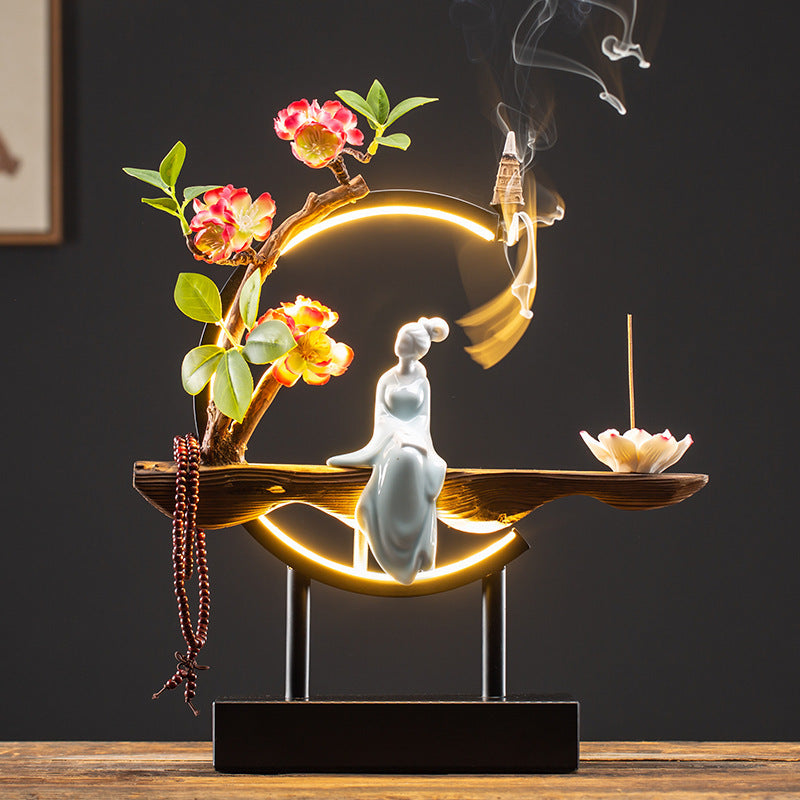 Illuminated Chinese lady incense ornament with red floral branch and smoke