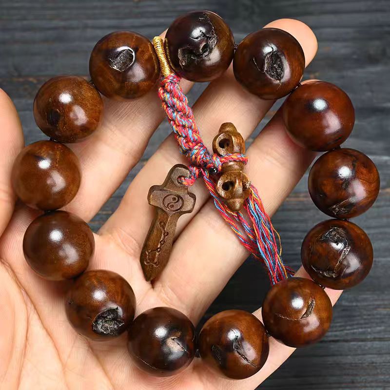 Lei Ji Zao wood bracelet with large polished round beads and carved Chinese symbol pendant