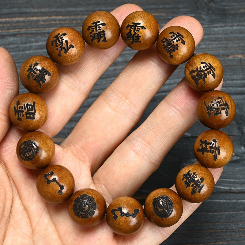 Supplier-described Lei Ji Zao wood bead bracelet engraved with Taoist-inspired script and symbolic motifs
