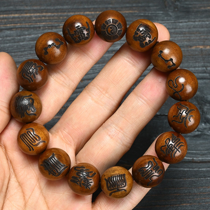 Lei Ji Zao-style wood bracelet with engraved Bagua and Taoist-inspired symbolic motifs on polished brown beads