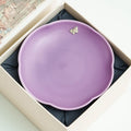 Lilac purple ceramic pot bearer photographed in warm studio light