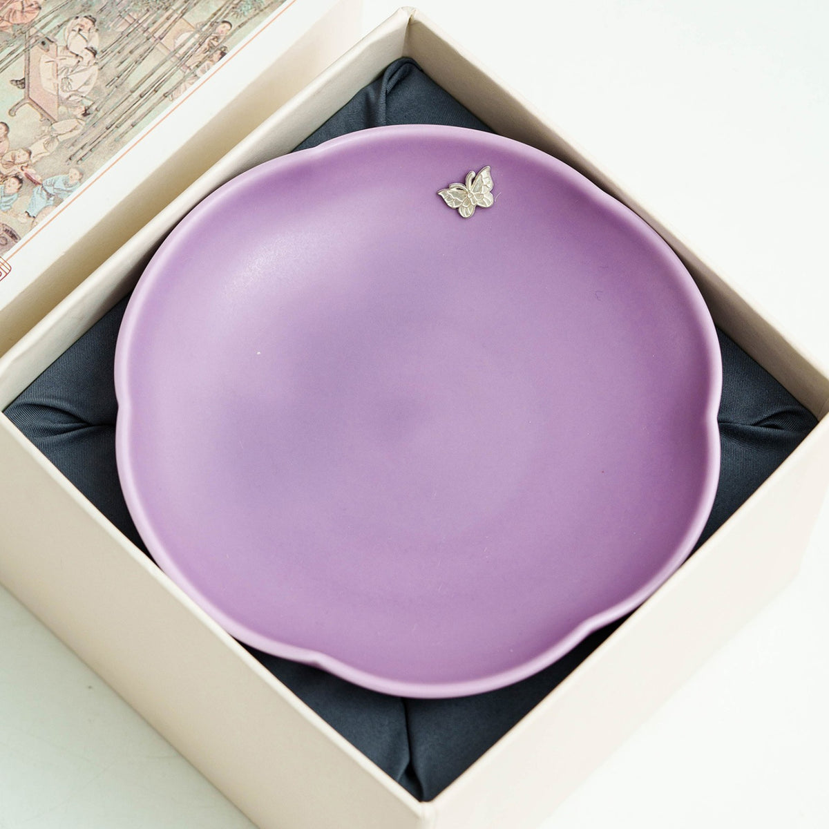 Lilac purple ceramic pot bearer photographed in warm studio light