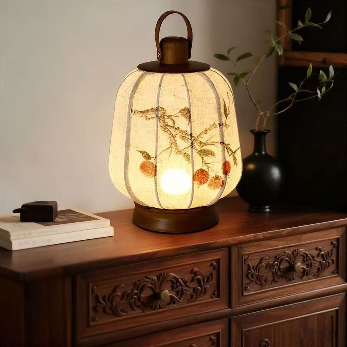 Plum blossom linen lantern lamp glowing on carved wood cabinet