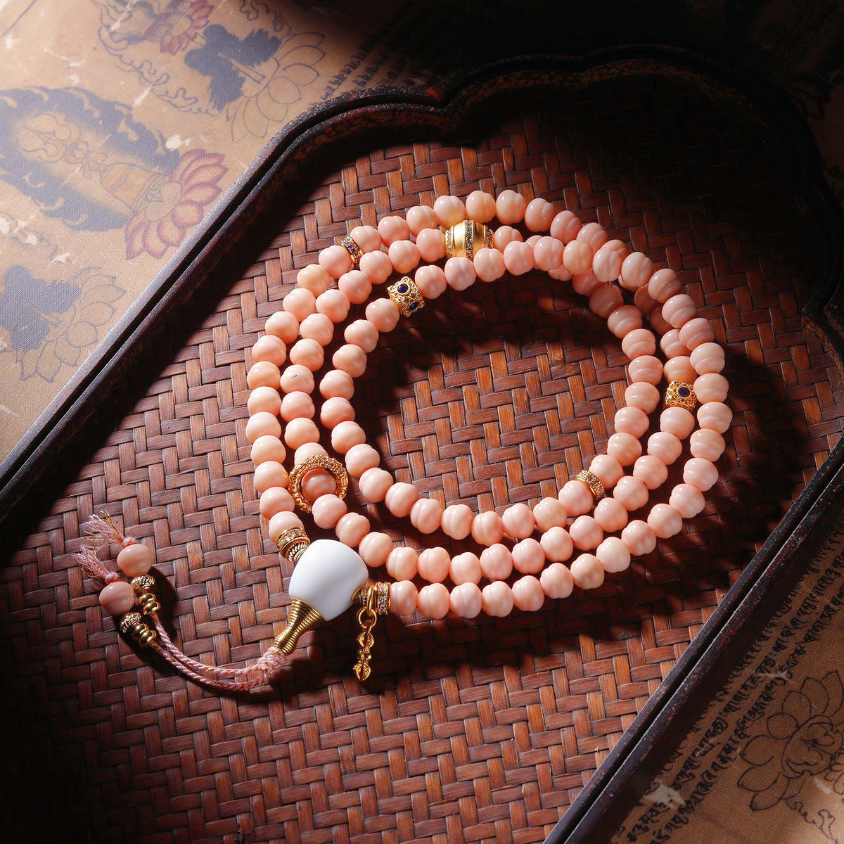 Pink Longji Bodhi hand mala with barrel beads, white focal element and gold-tone decorative accents