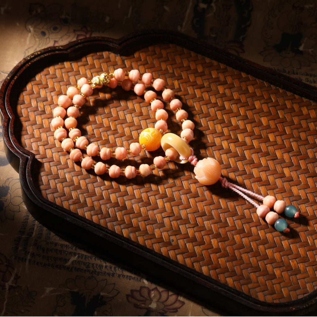 Pink Longji Bodhi hand mala with warm yellow focal beads and New Chinese tassel styling