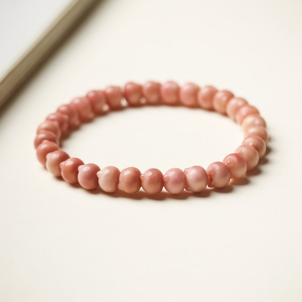 Pink Longji Bodhi small cat-head shaped bead bracelet in soft natural light