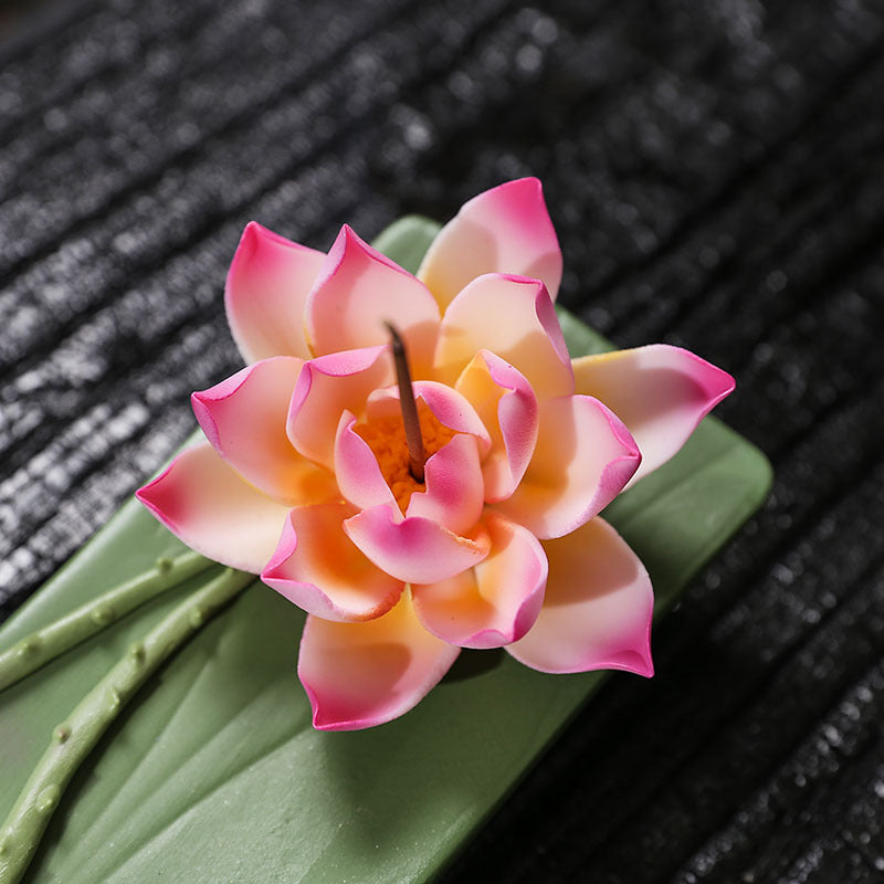 Close-up of pink edged lotus flower ceramic incense stick holder
