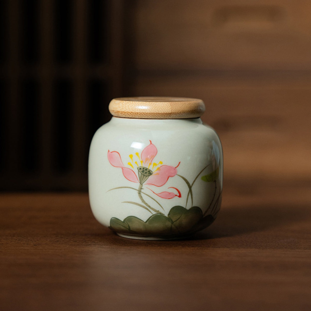Lotus ceramic tea storage jar styled on a Chinese tea table