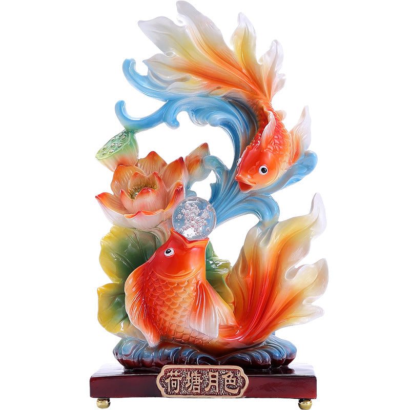 Resin goldfish lotus sculpture with flowing blue wave design
