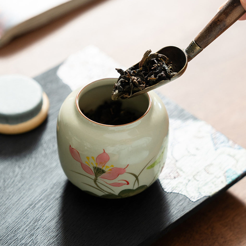 Hand-painted lotus ceramic jar storing loose leaf Chinese tea