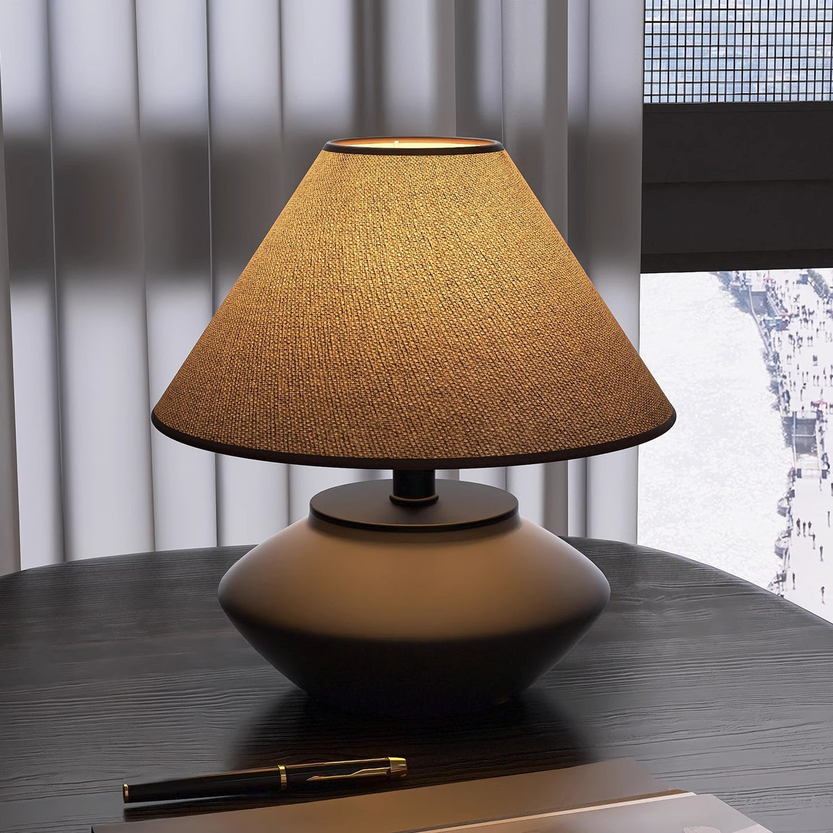 Low brown ceramic table lamp with cone linen shade on black desk