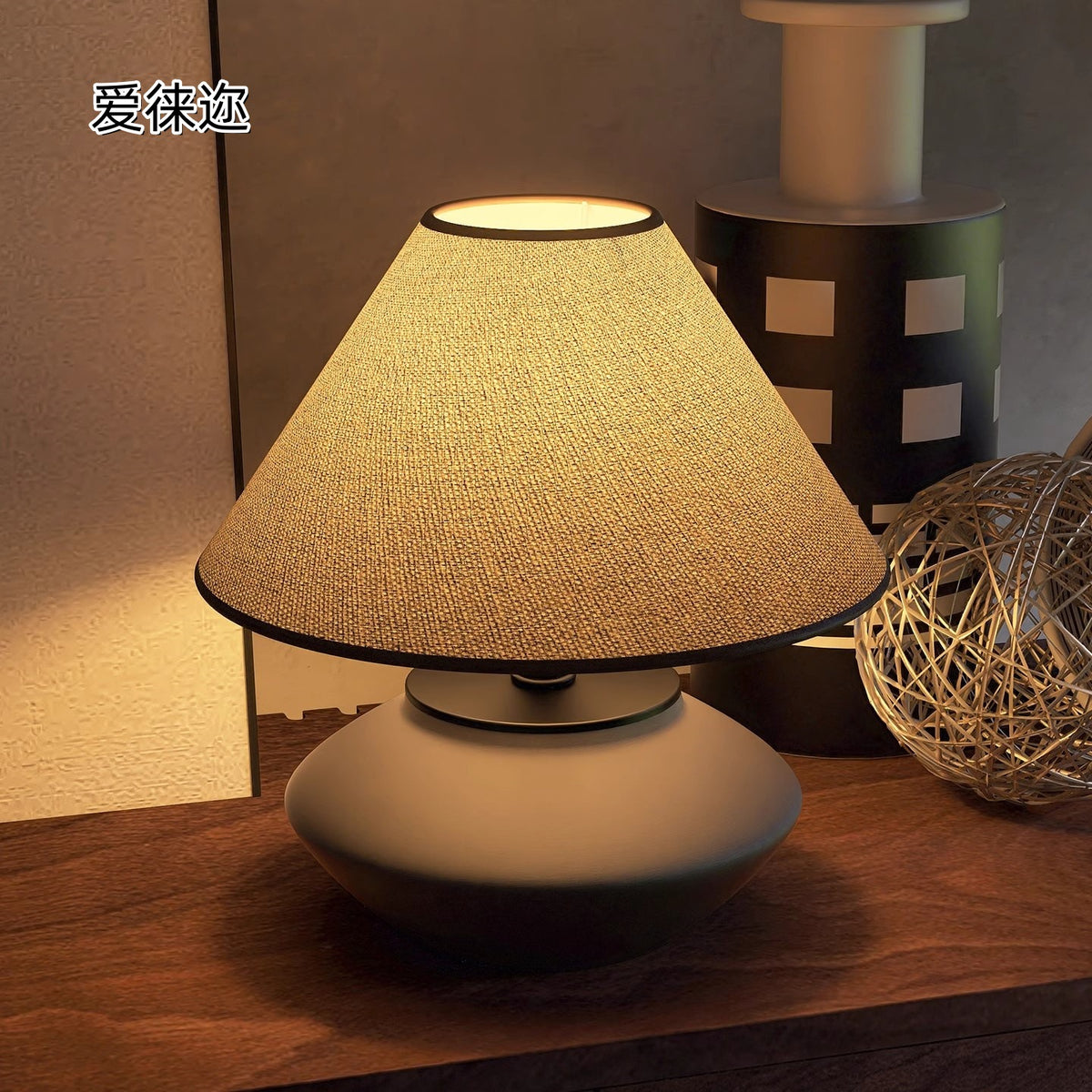 Low-profile ceramic lamp glowing warmly on wood table