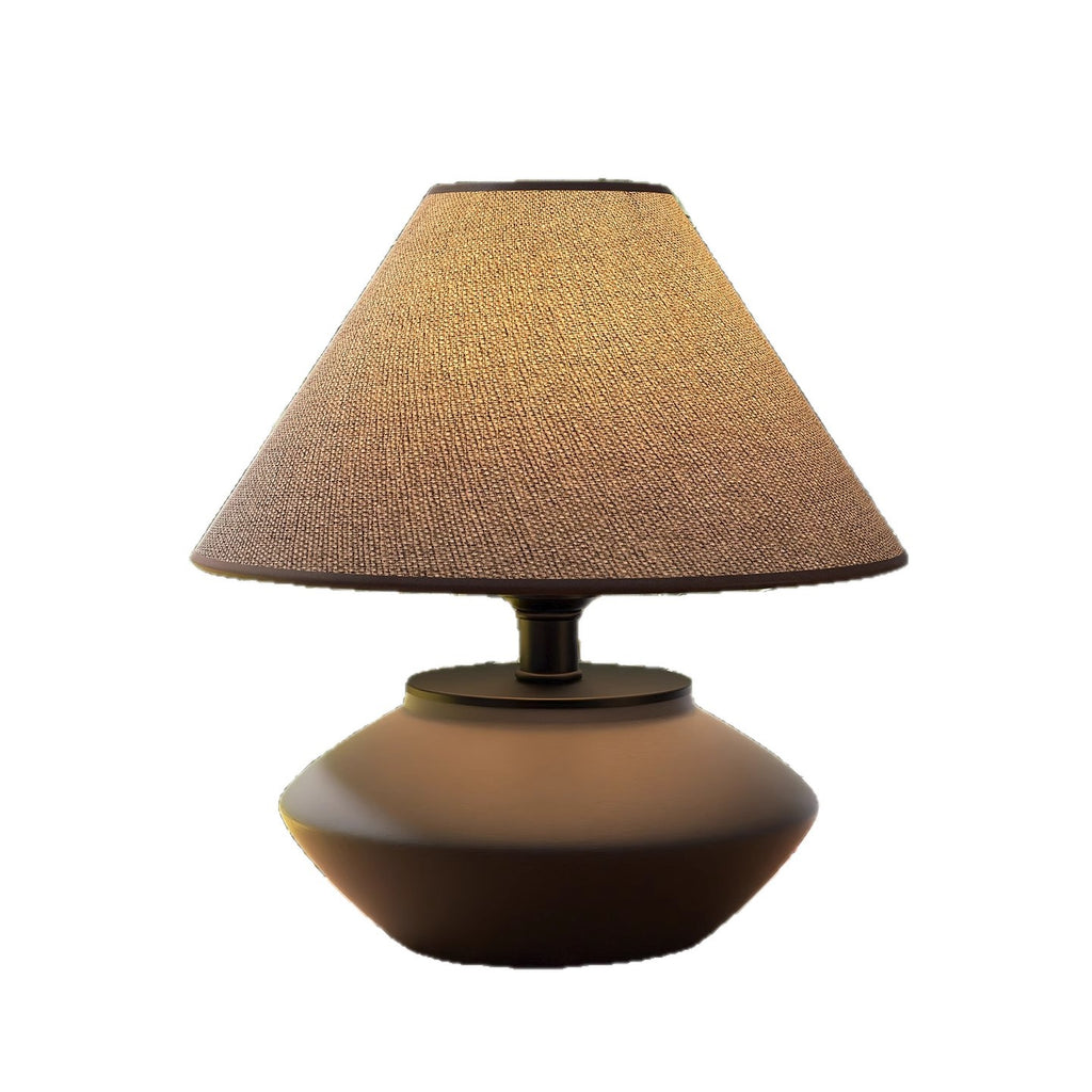 Compact low ceramic table lamp with flared linen shade on white background