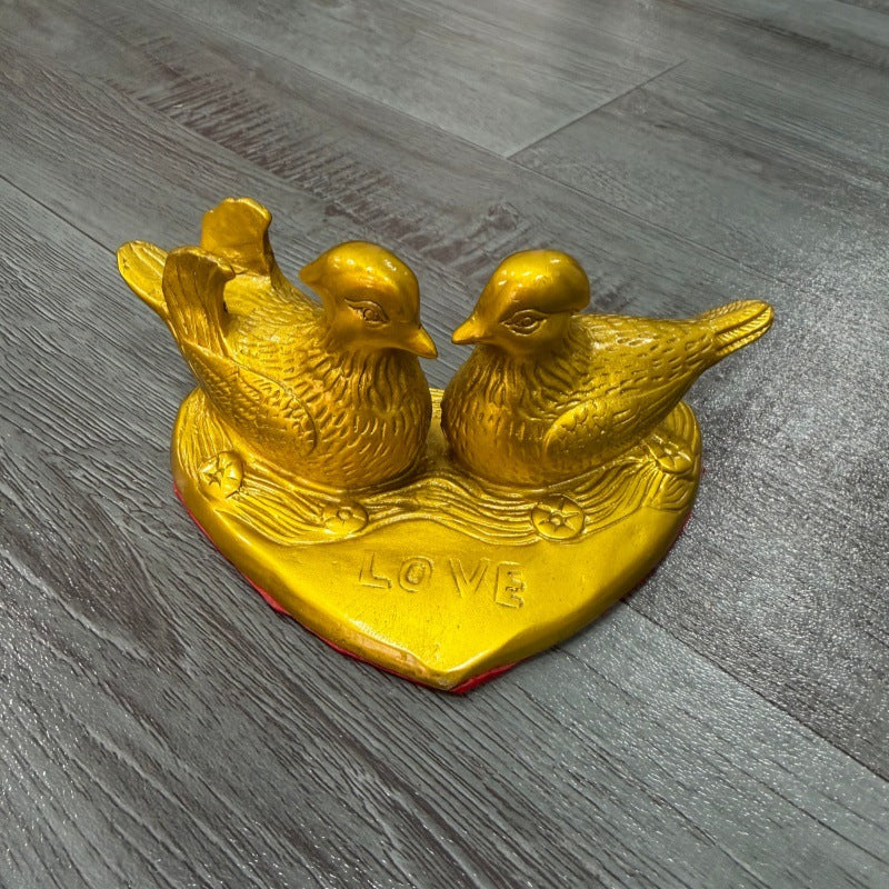 Golden mandarin duck couple on heart-shaped base for wedding and anniversary decor