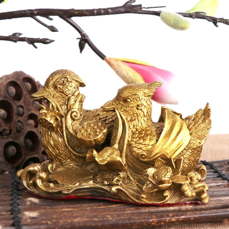 Ornate paired mandarin ducks with water and lotus motifs in antique gold finish