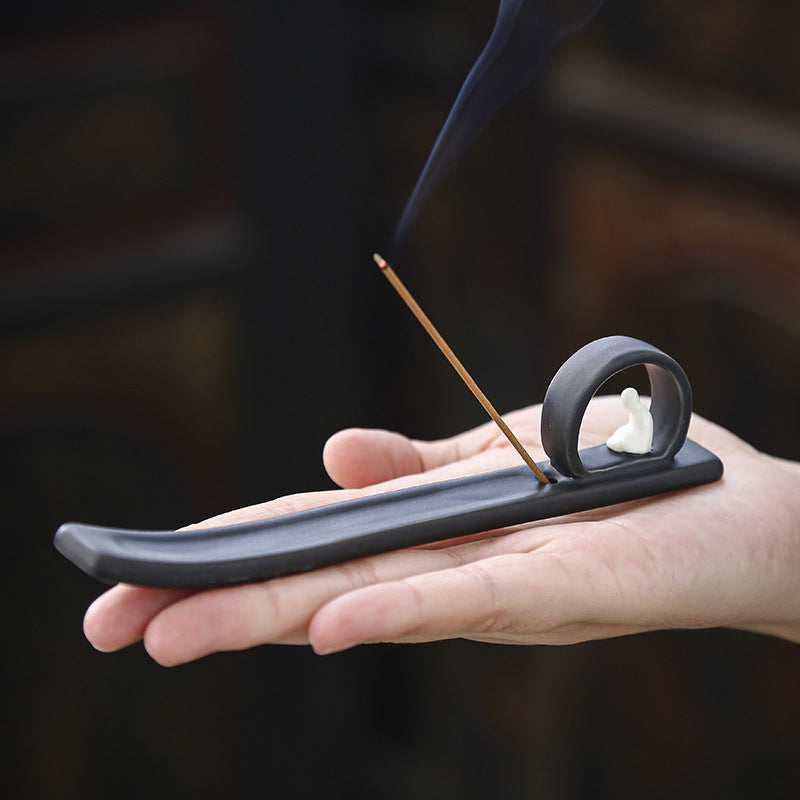 Palm-size minimalist Buddha incense ash catcher demonstrating compact scale