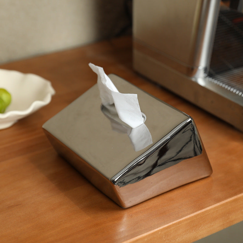 Electroplated silver geometric ceramic tissue box cover on wood table