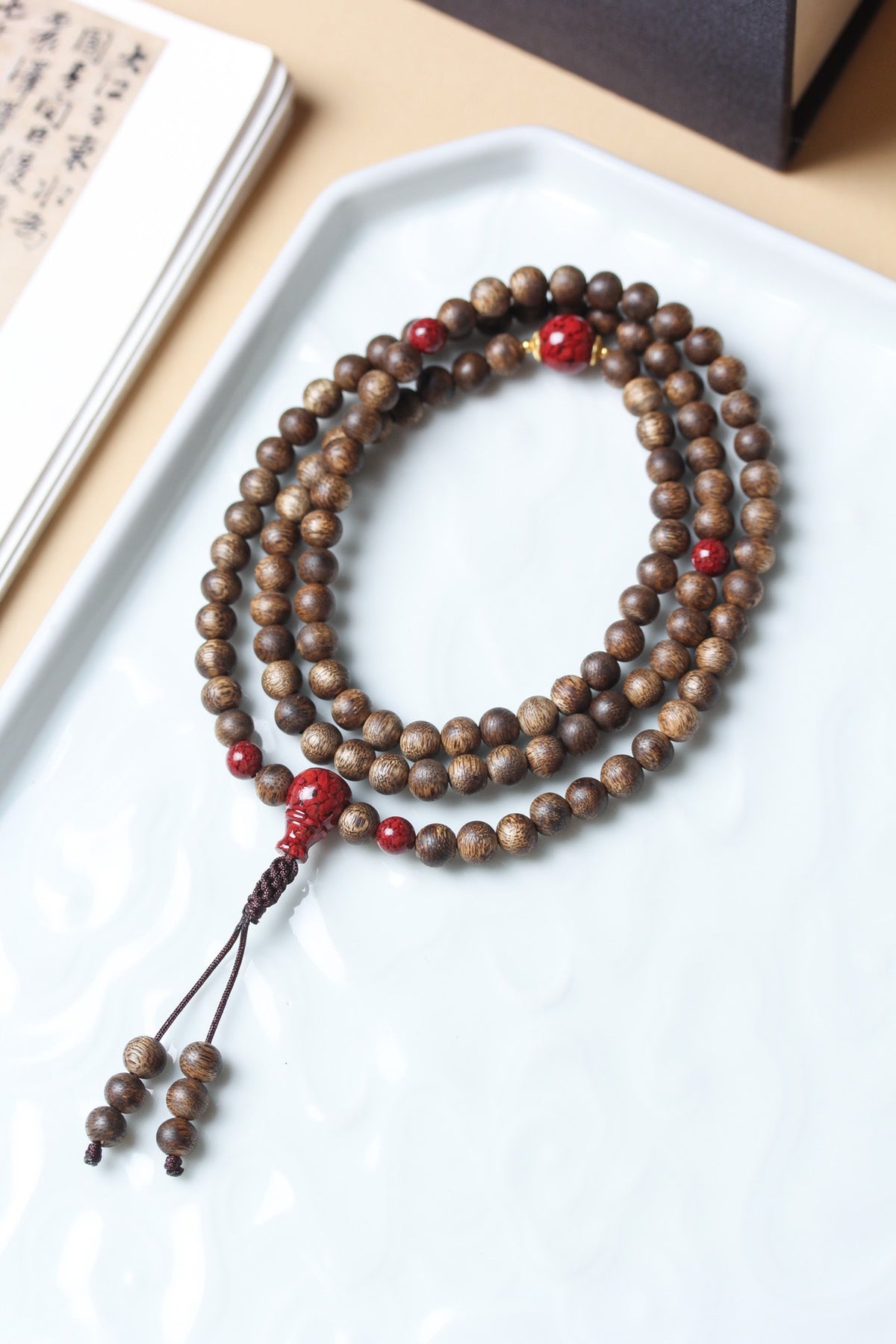 Natural agarwood 6mm multi-wrap mala bracelet with red cinnabar-tone accent beads and tassel