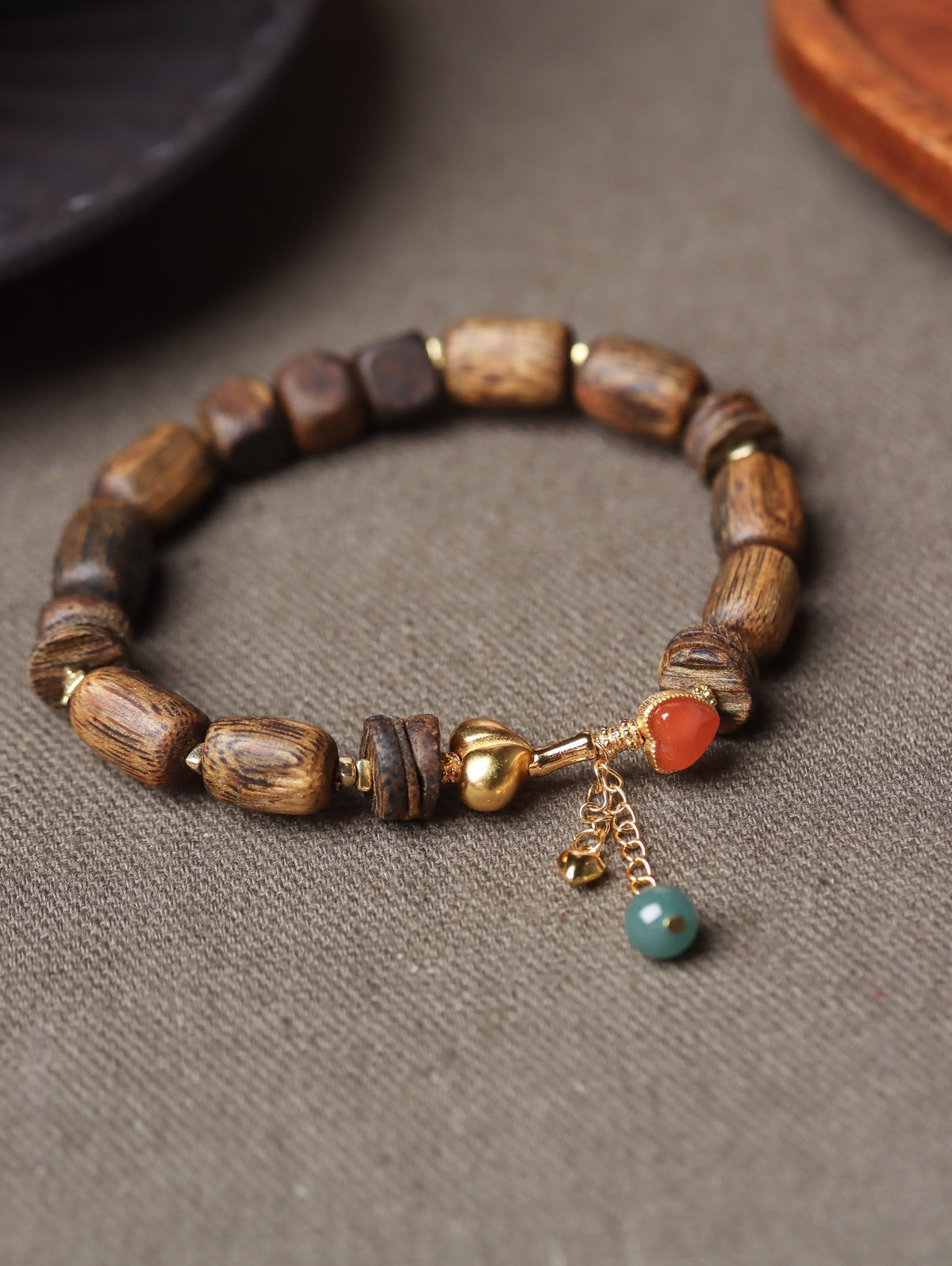 Natural agarwood irregular bead bracelet with red-orange and blue-green accent beads and gold-tone hardware