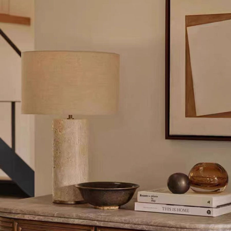 Natural cave stone table lamp with linen shade styled on a console