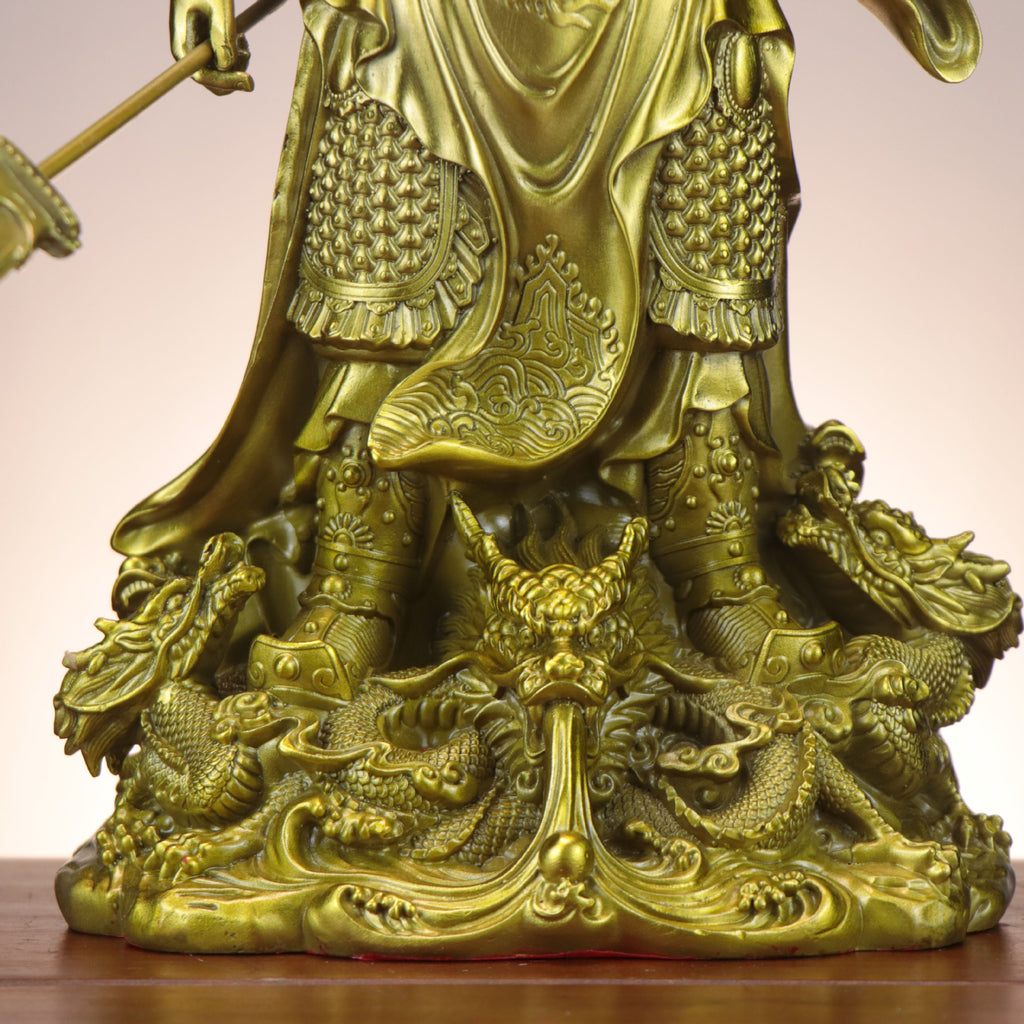 Close detail of Nine Dragon base on Chinese Guan Gong copperware statue with waves, armor, boots and dragon relief carving