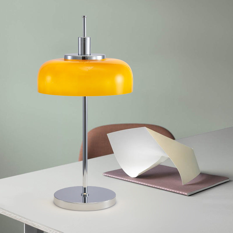 Orange glass Bauhaus lamp styled on console with books and decor