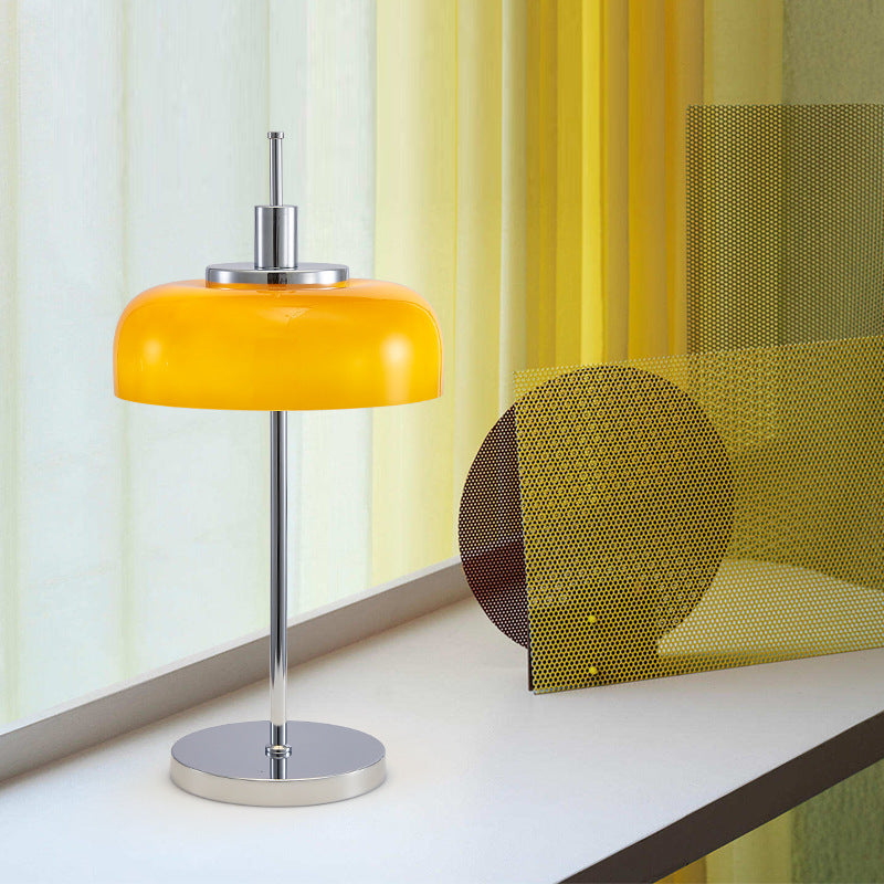 Orange Bauhaus glass table lamp beside abstract decor in modern interior