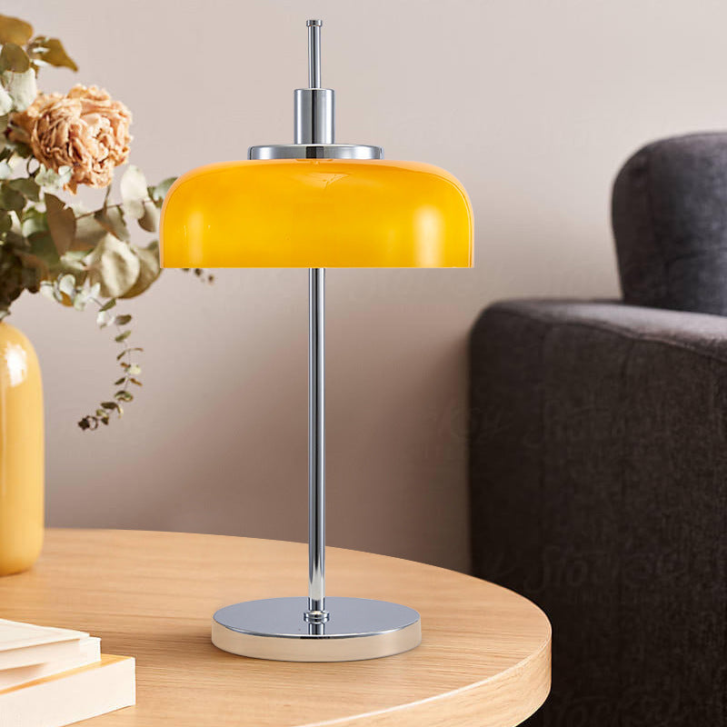 Orange glass dome table lamp styled on round wood side table