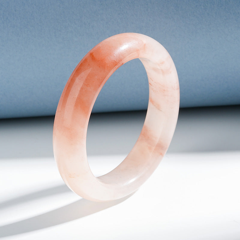 Natural peach and cream quartzite bangle angled view