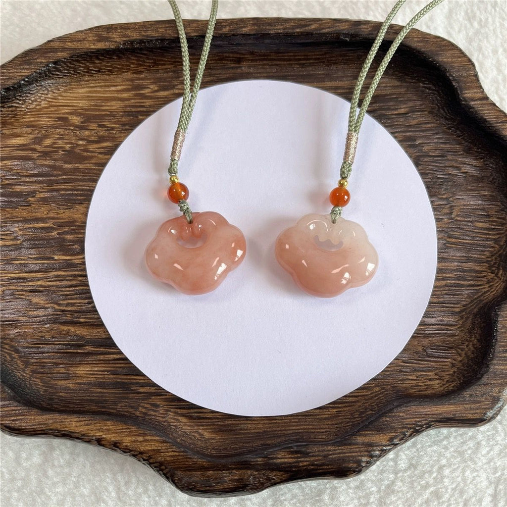 Peach-tone Ruyi lock stone pendants on woven cords