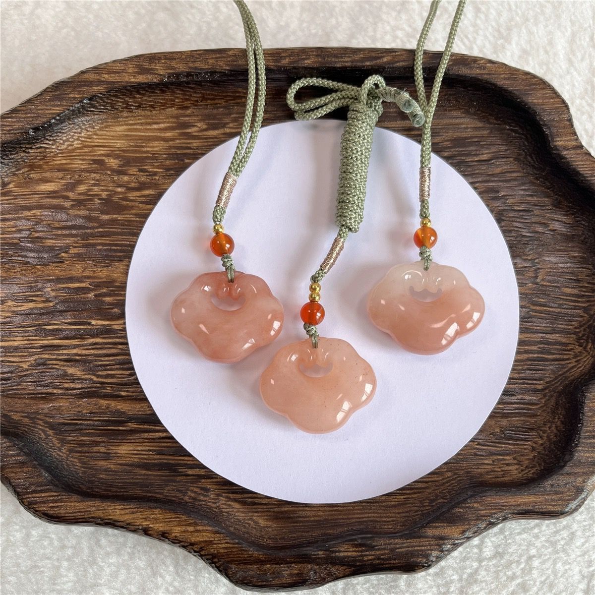 Peach-tone natural stone Ruyi lock pendant trio