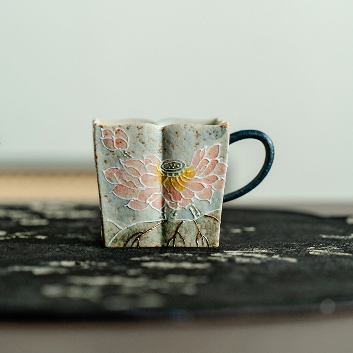 Pink lotus square ceramic tea mug presented beside its blue gift box