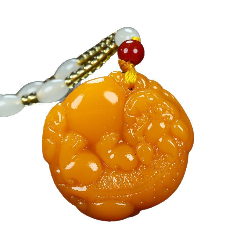Golden orange Pixiu round pendant isolated on white background