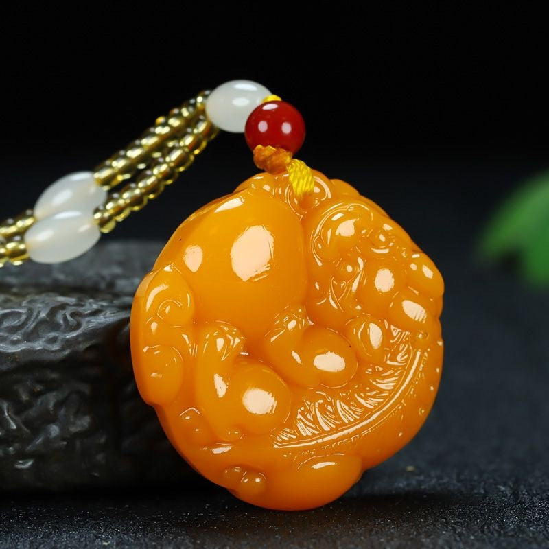 Carved Pixiu round pendant on dark display background
