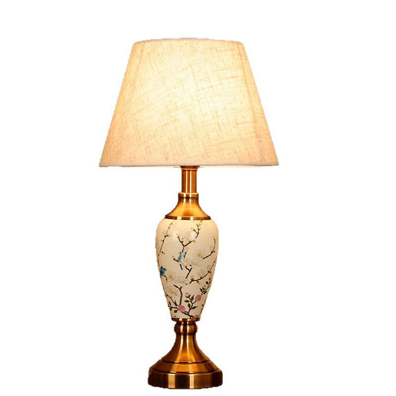 Magnolia branch porcelain lamp with tapered coarse linen shade