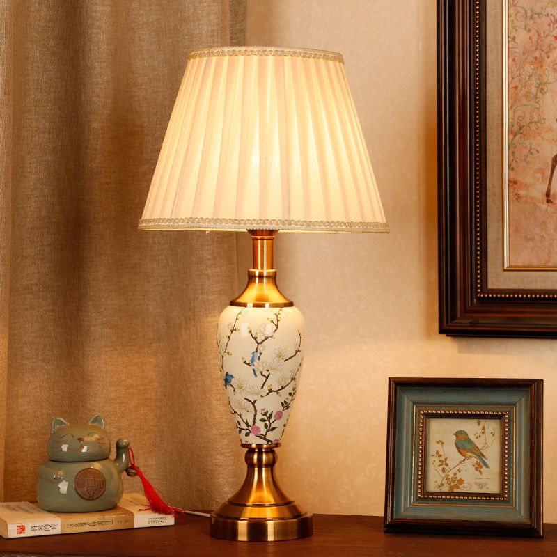 Magnolia branch porcelain table lamp with pleated shade in classic interior