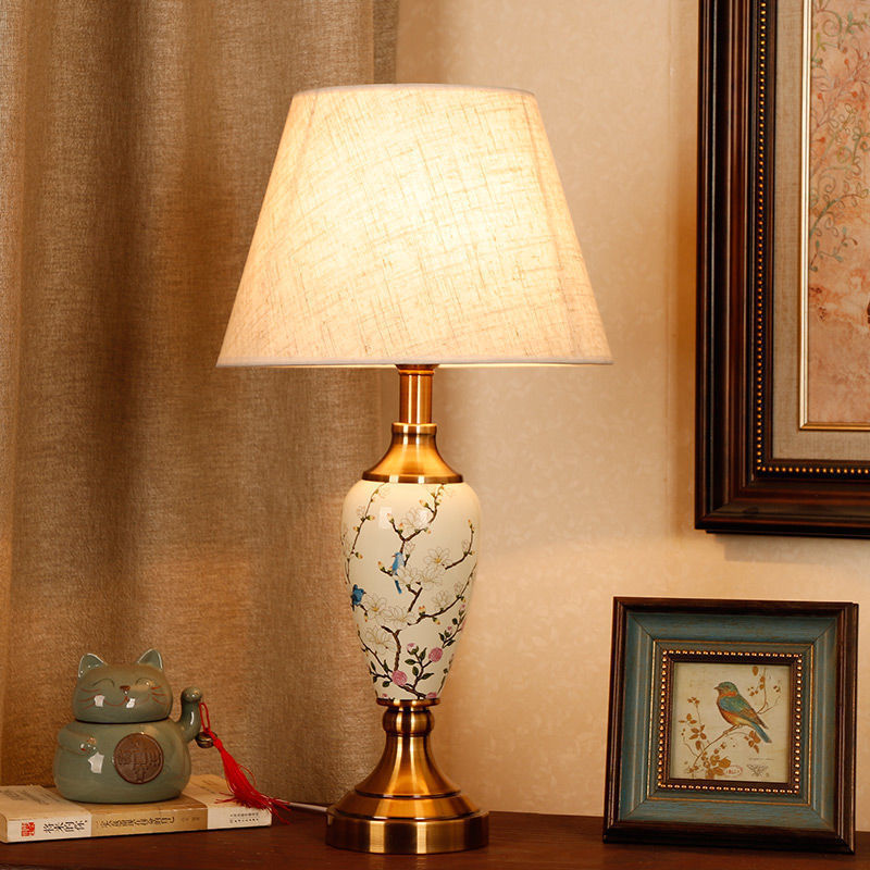 Magnolia branch porcelain table lamp styled on a classic wood console