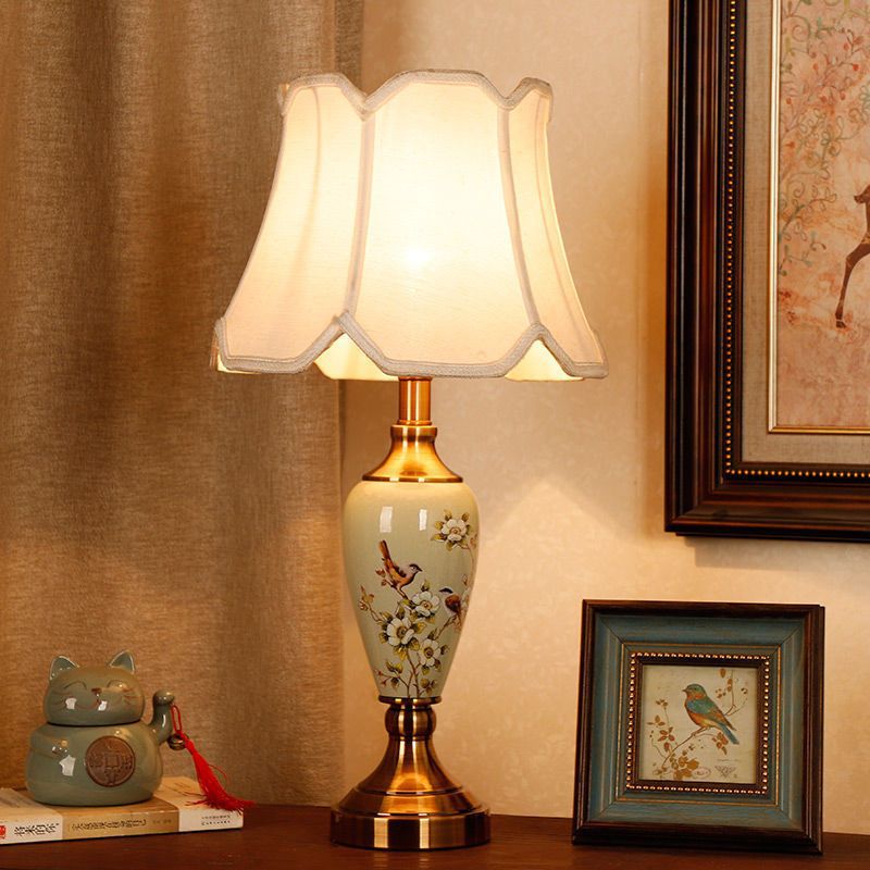 Porcelain table lamp with plum blossom and bird painting, brass-tone base and scalloped shade