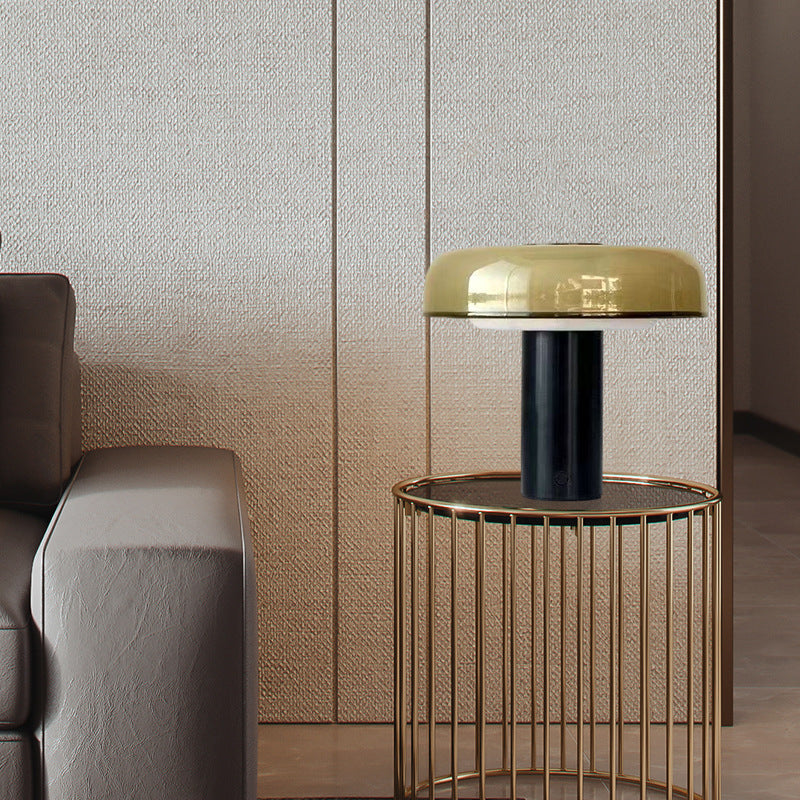 Postmodern amber glass mushroom table lamp styled beside sofa
